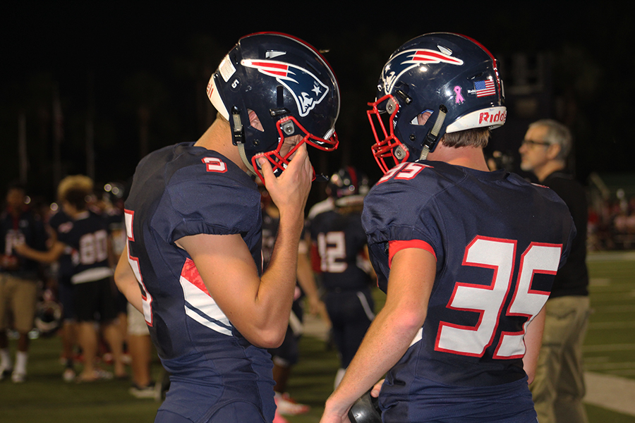 Senior Will Pikalow and junior Jett Boss discuss their last moves at the Tom Storey Field as the end of the game approaches on Friday, Oct. 20. Lake Brantley won with a score of 49, beating Oviedo by 21 points.