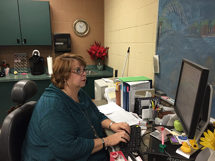 Julie Collins works at her desk in the media center during first lunch. Collins was announced Non-Instructional Employee of the Year on Oct. 2.