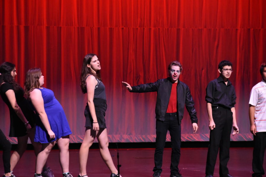 The theater troupe performs their ensemble number IN from the musical Carrie. Practicing on stage just before the opening night of Night of Scenes. 