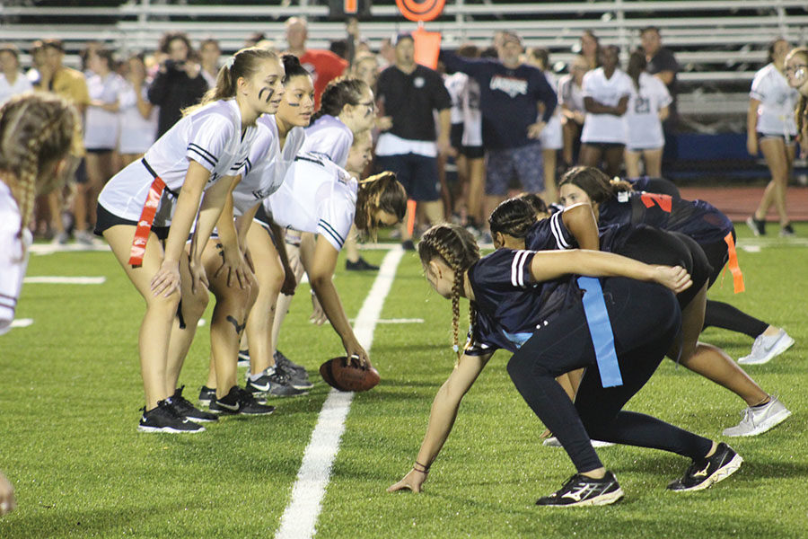 On Monday, Oct. 7, the Powderpuff players line up on the line of scrimmage for their next play.