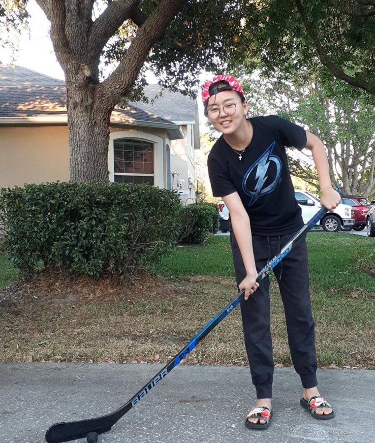 Since ice rinks are closed for quarantine, Sophomore Julia Moon practices stick-handling outside her front yard with an old hockey stick and taped golf ball.