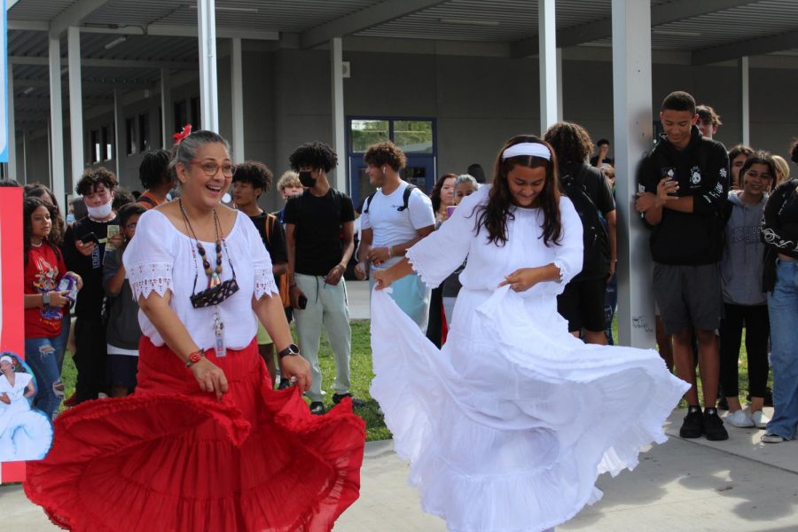 LIA and ESOL teacher Dianna Pagan jumps in and dances with junior Yulianys Rodriguez to ‘La Majestad Negra’ on Friday.