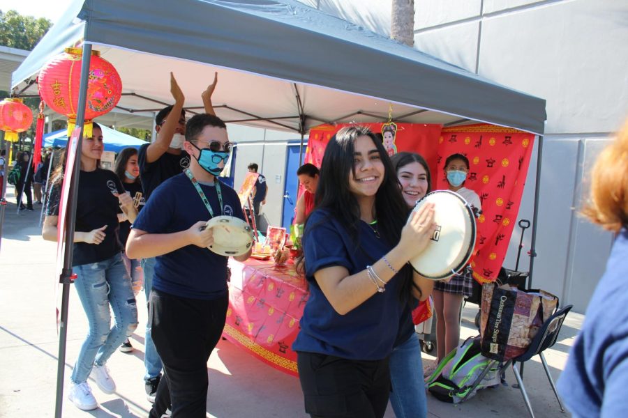 Latinos In Action (LIA) walk around the courtyard playing instruments from different Latino cultures during the Winter Festival on Friday, Dec. 10. LIA prepared a stand displaying some of the traditional instruments, also selling cotton candy for $1.