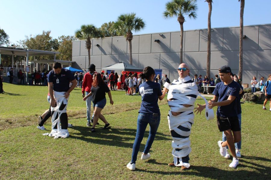 Assistant Principal Donald Fields Jr. and Principal Brian Blasewitz get wrapped in toilet paper by students in the “Building a Snowman” competition at the Winter Festival. Fields’ team was the fastest to finish and won against Blasewitz.