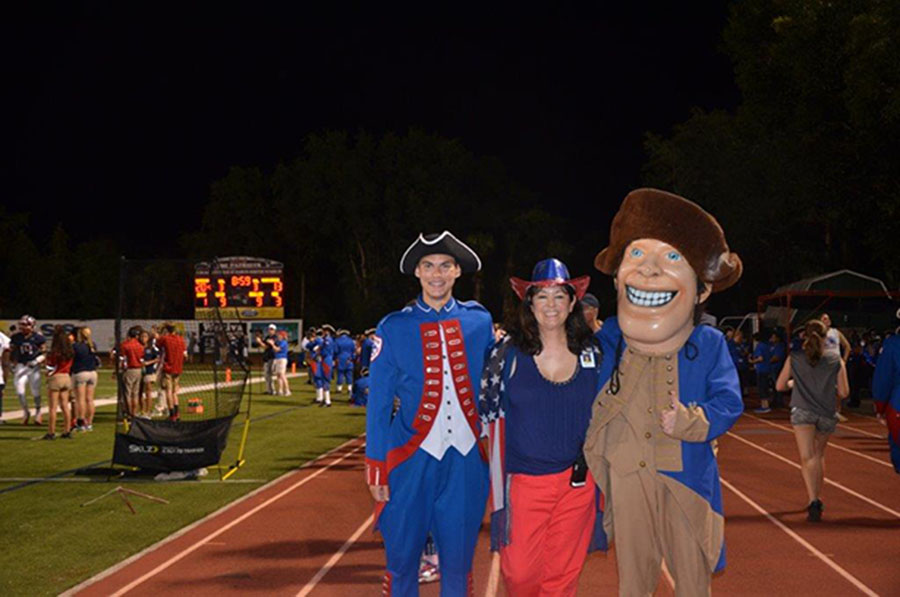 Principal Dr.Trent Daniel, homecoming king Matt Little, and Patriot Pete pose for a picture together on September 7, during the homecoming football game. The Patriots defeated the Winter Haven Blue Devils 35-28.