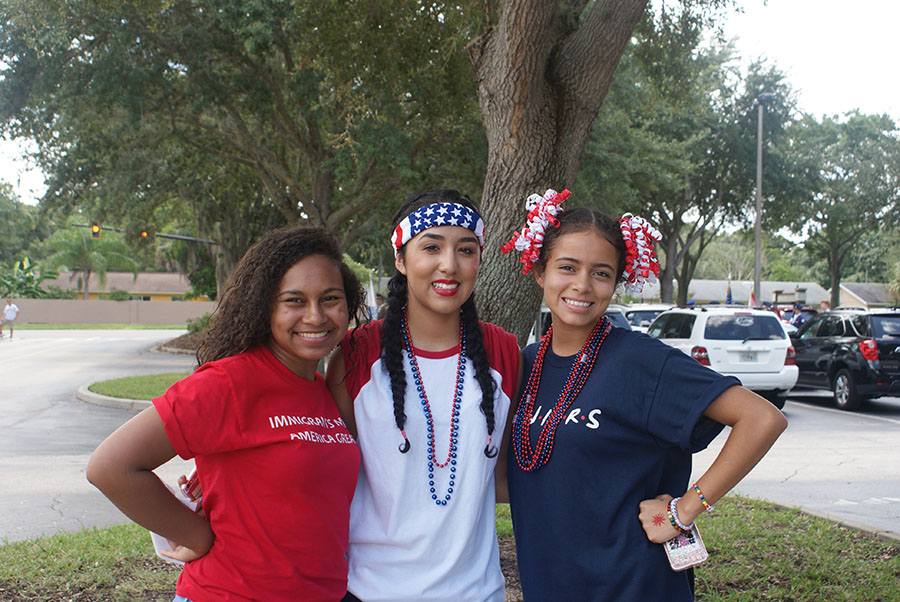 Seniors Nicole Romero and Emily Martinez pose alongside junior Danyele Heier near the student parking lot entrance as they wait for the parade to start on September 7. They oversee the commotion and excitement as everyone prepares for the parade.