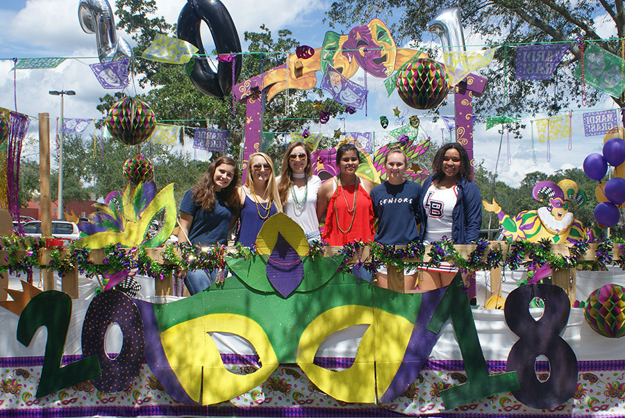 Senior student council representatives pose on top of their class float in the student parking lot before the parade on September 7. Many hours were spent planning and creating the decorations that went into the float.