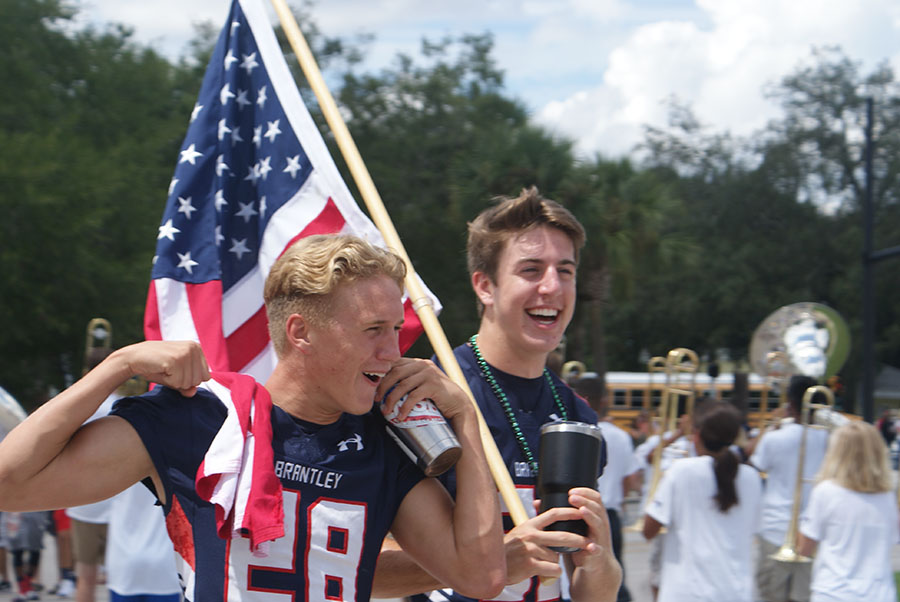 Juniors Nolan Sanders and Carson Rigby pose for the cheering crowd as they walk by during the parade on September 7th. The followed the senior float and the varsity football players and cheerleaders.