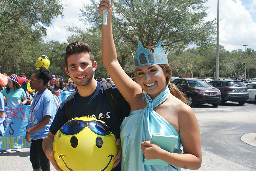 Senior Caroline Roman and Jordan Greenburg pose before the parade in the student parking lot on September 7th. Roman was this year’s statue of liberty and walked with Peer Counseling in the parade.