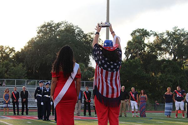 On Thursday August 7 on the Tom Storey field, last year’s homecoming queen Tyanna DeSanto and principal Dr. Trent Daniel wait for the announcement of homecoming king. Senior Matt Little was voted king out of a running of five other students.