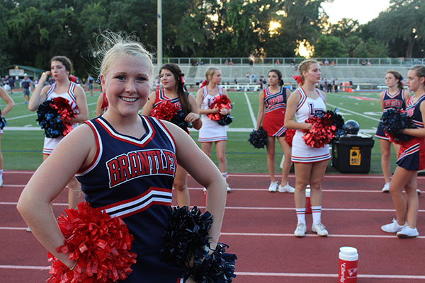 Freshman Devin Marie Ogier shows her school spirit with a big smile on Thursday September 7th at the homecoming game at the Tom Storey Field. “Cheerleading has given me the opportunity to serve the school and community with my friends.” Ogier said.