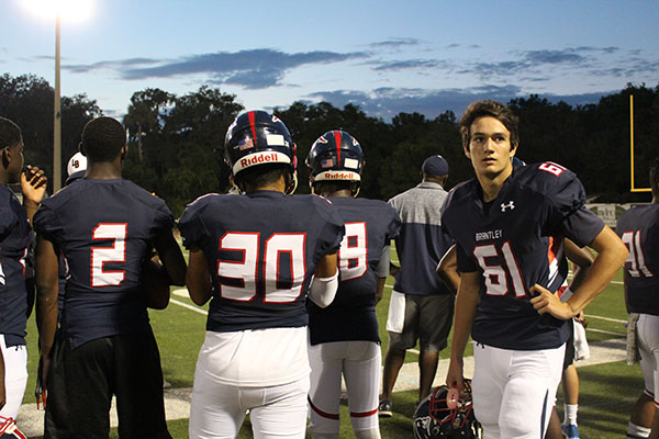 On Thursday, September 7, on the Tom Storey Field, the football players on the sidelines watch a play against Winter Haven High School. The football team won by a score of 35 to 28.
