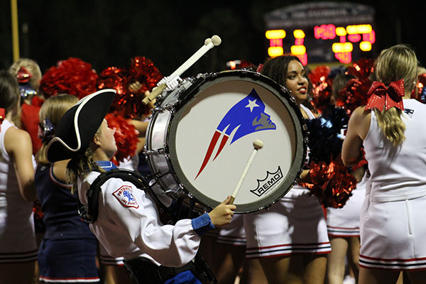 Sophomore Emma Vick plays with the drumline during third quarter of the homecoming game on Thursday, September 7. Cheerleaders and students always dance and cheer on their team alongside the drumline.