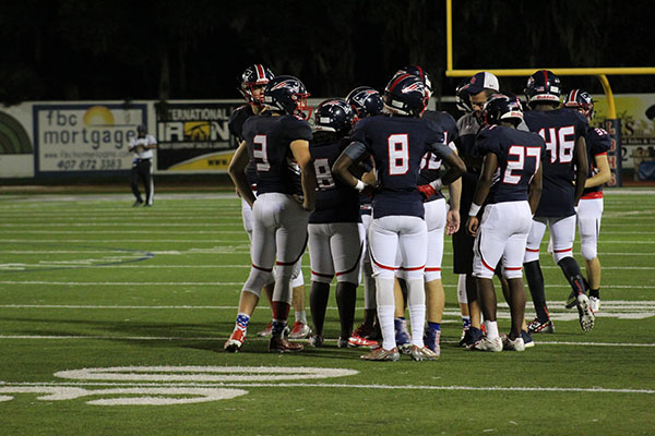On Thursday, September 7 on the Tom Storey Field, the football team huddles during a timeout to discuss their next play. Working together, the team won the game with a score of 35.
