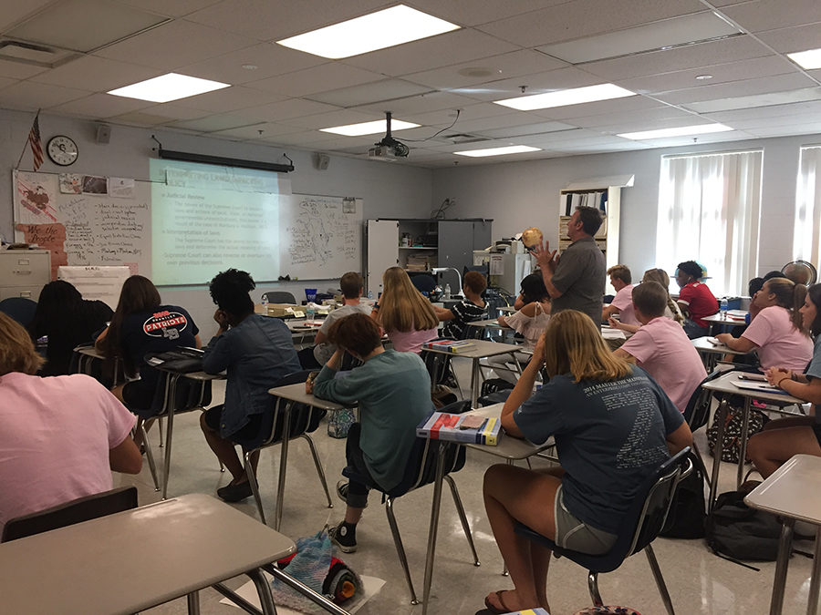 Dr. Bill Geeslin is teaching a lesson to his 5th period Advanced Placement American Government class in room 8-206 on Friday, Oct. 20. Through a PowerPoint, Geeslin taught his students about laws that impacted policy in the Supreme Court.