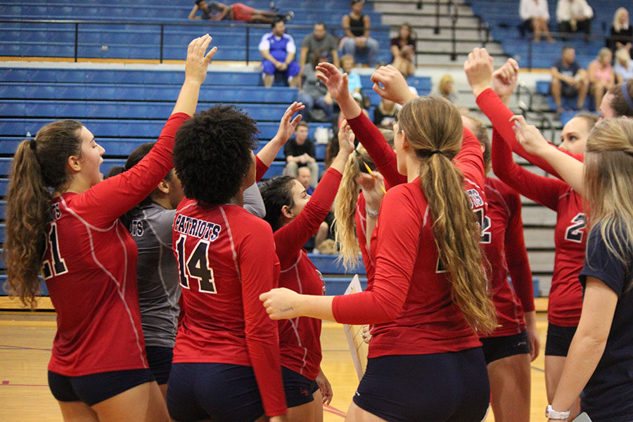 The varsity volleyball team huddles together during a water break to discuss plays and motivate each other during the Wednesday Sept. 27 home game against Lyman. The team finished off the game with a win of  3-2.