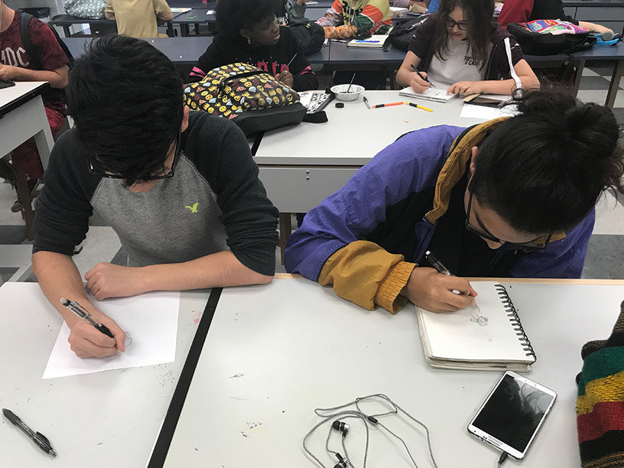 Seniors Angel Rodriguez and Gabriel Agudelo work on their Inktober pieces during National Art Honor Society meeting on Friday, Oct.6. The president contributed half of the meeting to students creating Inktober pieces and discussing them as a group. 

