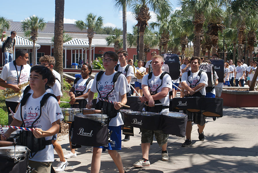The drumline walks towards the main gym before the start of the pep rally on Thursday, September 28. The March through the campus allows students to get hyped up before the pep rally begins.