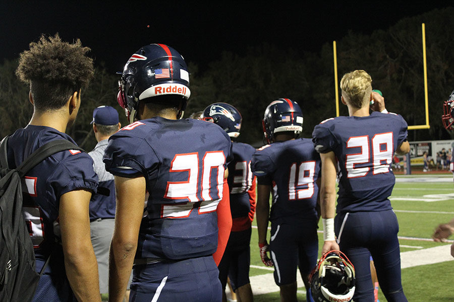 On Thursday, Sept. 28, members from the varsity football team watch a play against Seminole High School at the Tom Storey Field. The Patriots lost to the Noles with a score of 31-6.
