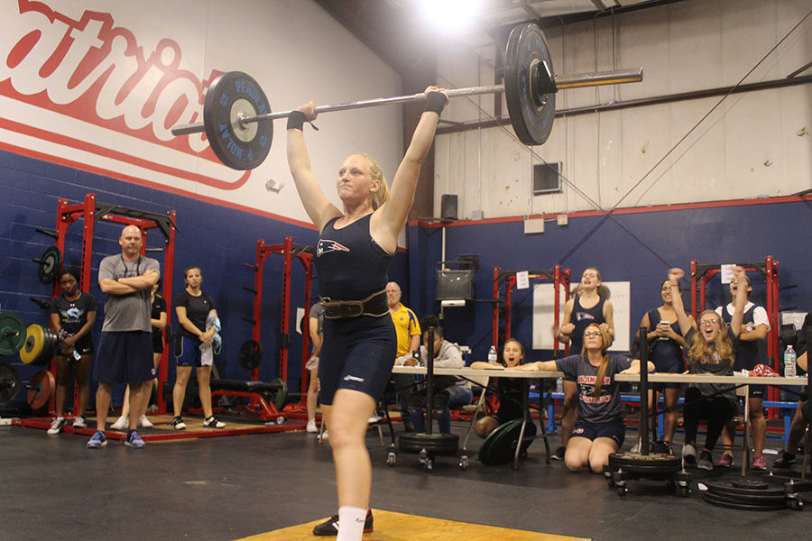 Junior Elena Korkes successfully lifts 135 pounds during the weightlifting meet on Wednesday, Nov. 1. The team cheered her on through one of the heavier lifts that she completed.
