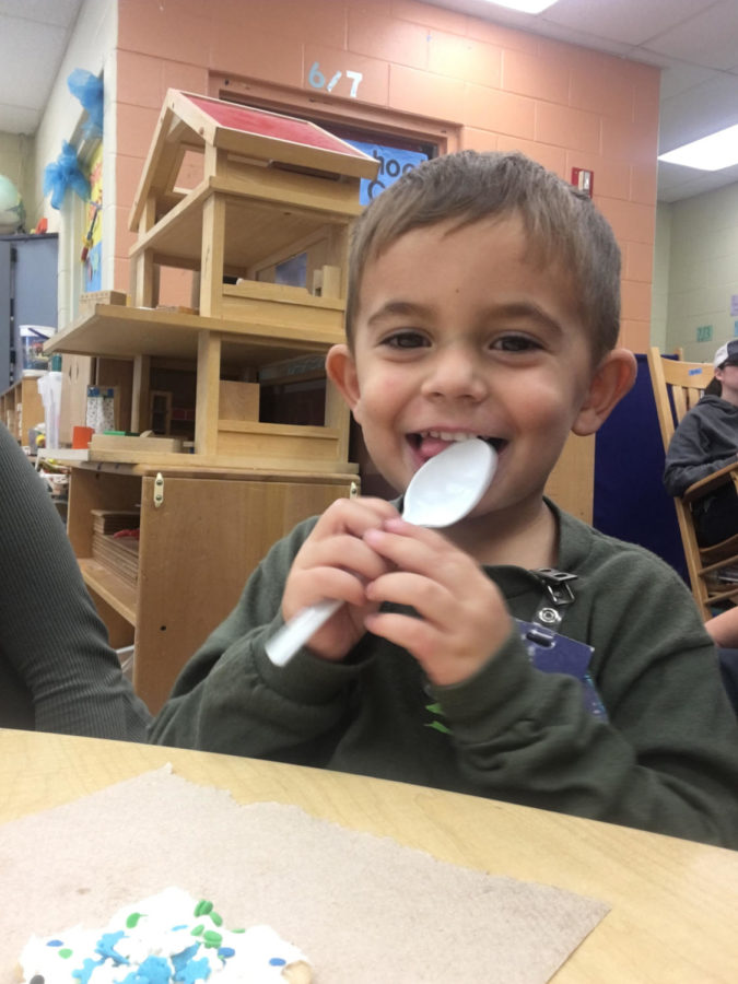 Three-year-old Carter Perales enjoys himself after the yearly December Gingerbread Hunt lead by the Early Childhood class. Before the students could join the cookie decorating, they first had to find their gingerbread that had been hidden by instructor Andrea Lesko. 