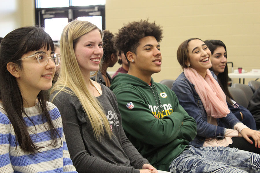 In the community room on Tuesday, Jan. 16, seniors Amanda Romero, Liberty Ballard along with juniors Anthony Colenburg and Abigail Perez laugh at a game their fellow peers are partaking in. During this game, students had to retrieve coins from the bottom of pantyhose by only using their hands.
