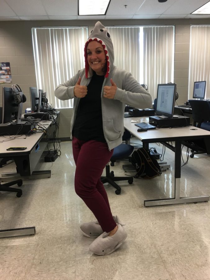 Newspaper teacher and avid shark enthusiast, Katie Turkelson, parades around the classroom showing off her new shark slippers and classic shark jacket to the newspaper students on Feb. 12. “It’s not that I admire sharks, it’s that sharks have brought me closer to my students,” Turkelson said. “Therefore, I really enjoy have shark memorabilia and things all around my classroom.” 