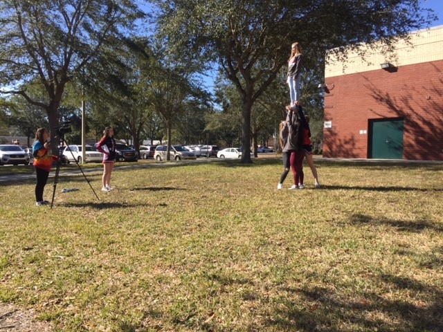 Lake Brantley and Lake Mary cheerleaders perform stunts as part of a commercial during the rivalry respect summit. The summit was held in the Community room on Wednesday January 17.