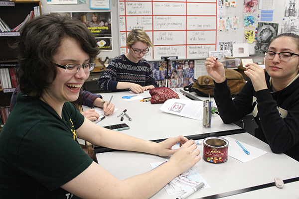 During National Art Honor Society on Friday, Feb. 23, students August Esbjorn-Witt, Camille Gros, and Alexis Casaccio all laugh and joke around while completing their cards for Marjory Stoneman Douglas. The students drew the schools mascot, an eagle, with messages of warmth and strength. 