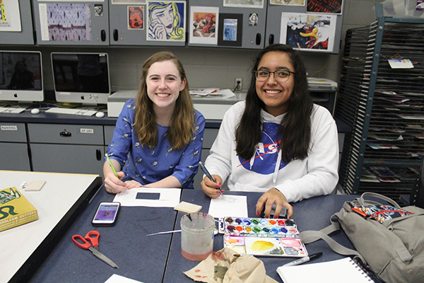 Sophomores Alicia Stuffy and Giselle Hernandez are water coloring their cards to send to the victims of the Marjory Stoneman Douglas shooting on Friday, Feb. 23. The students took a quick pause from their hard work in order to smile for a photo.  It felt nice to be able to cheer up the students at SD[Stoneman Douglas], sophomore Giselle Hernandez said. So many people made cards with different concepts it was cool. 