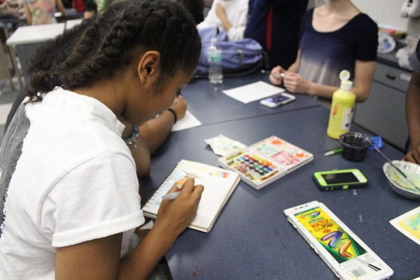 Junior Renee Gooden watercolors a sketchbook page during the Art National Honor Society meeting on Friday, Feb. 23. Gooden began sketching after she had completed her contribution to the cards for the students of Marjory Stoneman Douglas. 