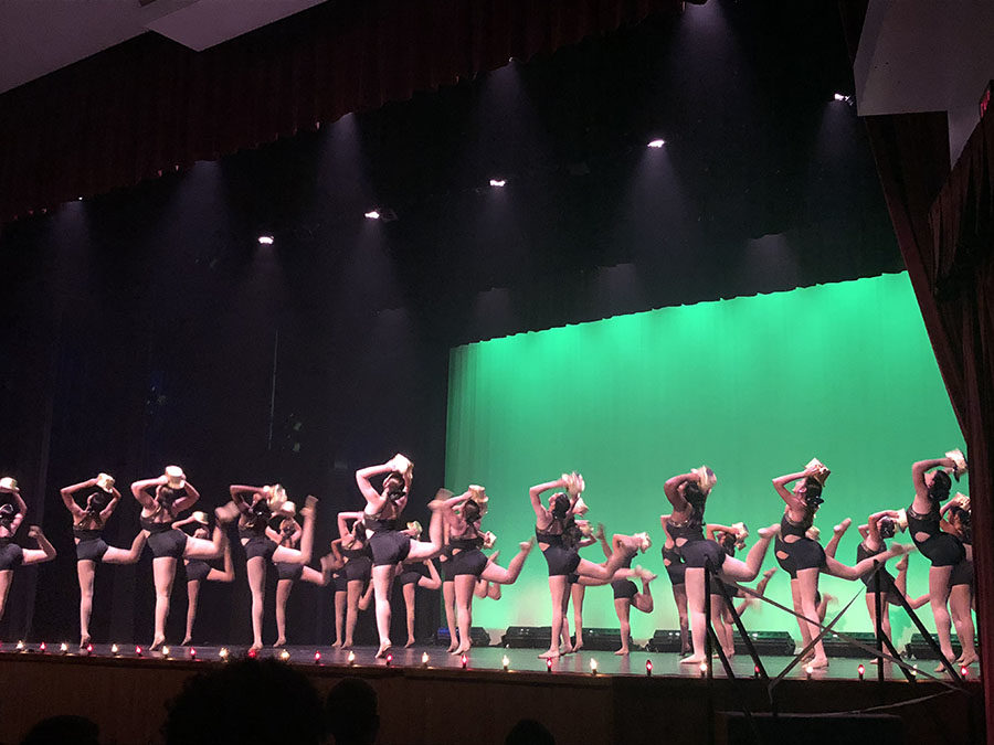 Varsity Sparklers dance to the song “I Hope I Get It” on May 10 at the Spring Dance Show. The dancers added hats to their routine as props to liven up the performance.
