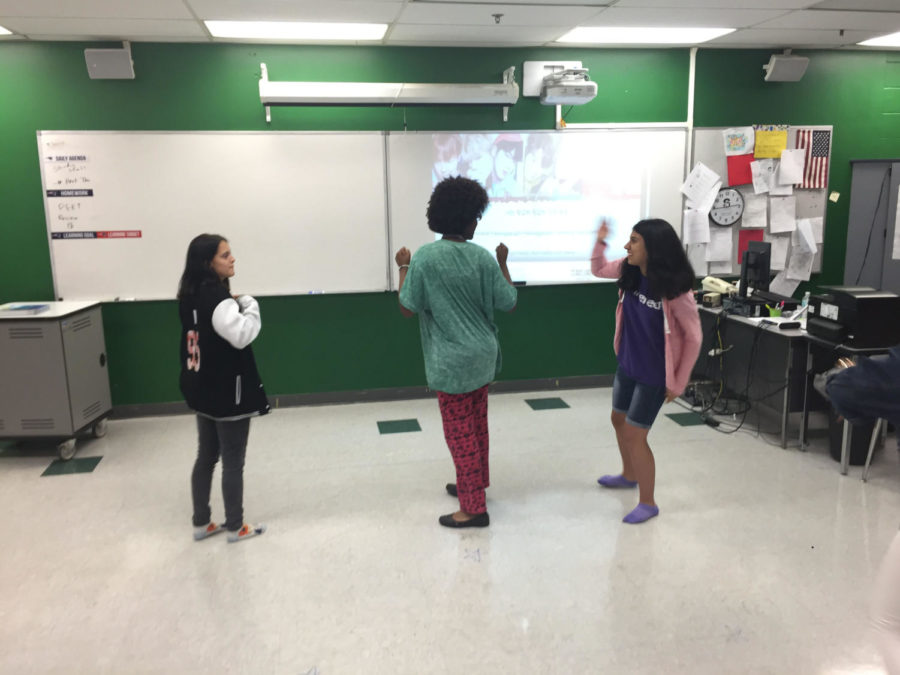 In room 6-205, on Thurs., May 17, junior Kayti Campbell, sophomore Jordan Moser and freshman Sabrina Valdivia cheer after they accomplish a hard part in their dance routine. The dance move was a complicated spin that took the group weeks to perfect.

