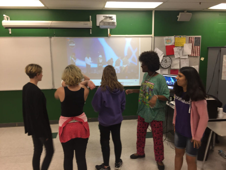 Members of the K-Pop Club watch the music video for “Mic Drop” by the band BTS on Thurs., May 17, in room 6-205, so they can learn the dance moves. The club members intensely studied every move of the band members in order to be able to bring their replication of the dance routine to perfection.

