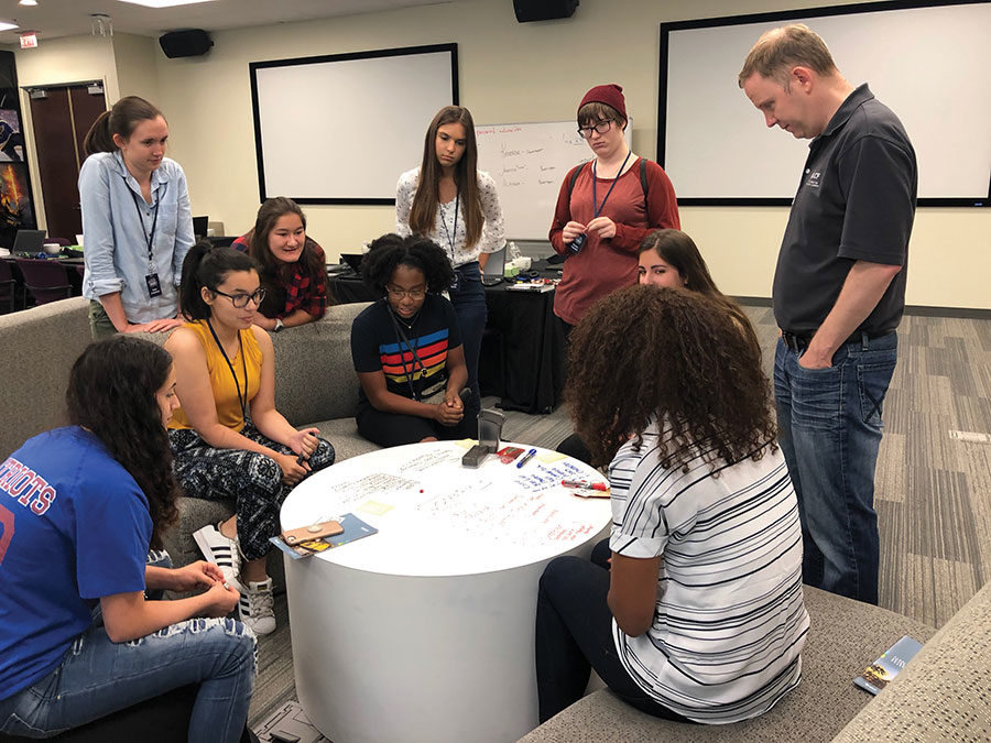 Juniors and seniors from Seminole and Orange county schools play a group game called Love Letter at Electronic Arts. Ten students were chosen to go to Electronic Arts to practice and learn computer science techniques.