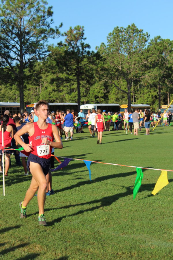 Senior and varsity cross country runner Gavin Koerth runs during the Deland Invitational on Sept. 1. The participants run on a 5k course and the varsity team placed fifth at the meet. 