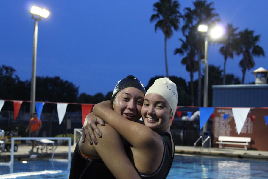  Senior Morgan Whipple and Junior Carrlee Crocker use their short water break, often used to take lanes lines out of the pool, to have some fun. “Preseason as a whole can be grueling, ”says Whipple. But to me I think the dryland practices and leg sets are the most grueling. 