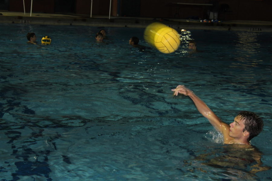 The signature bright yellow water polo ball is hurled across the pool to Sophomore Isaac Benjamin. While attempting to catch passes players must also tread to keep their heads and shoulders above the water. The constant movement is one of the reasons why water polo is considered one of the most challenging sports of all time. 