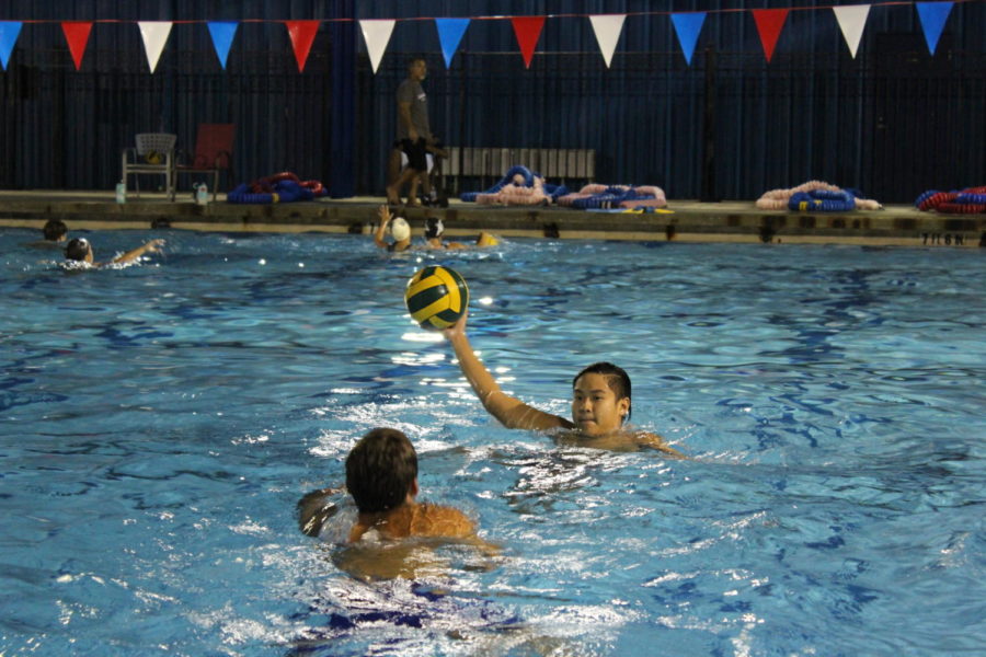 Sophomore Alexander Nyugen is seen here practicing a defense drill. By holding his hand up high this drill emphasizes both defense skills and steadiness for the offensive player. Due to the fact that water polo is a full contact sport these drills often involve a lot of pushing and splashing. 