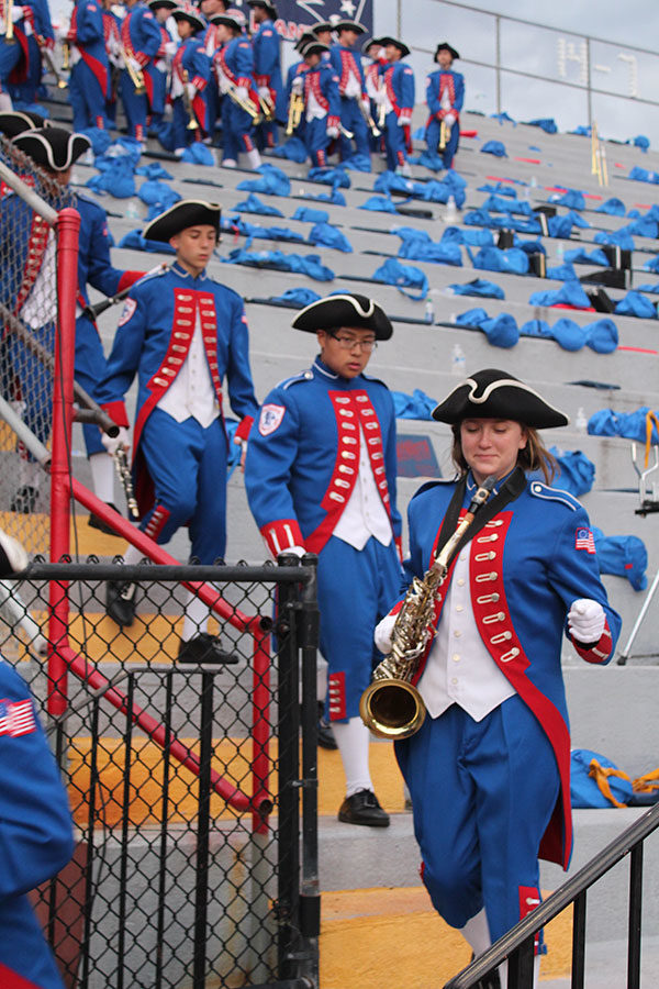 The marching patriots exit the stands and walk onto the track in order to prepare for the halftime show. The football game against Hagerty High School took place on Friday, Aug. 24 on Tom Storey Field, with the Patriots winning with a score of 35-17. 

