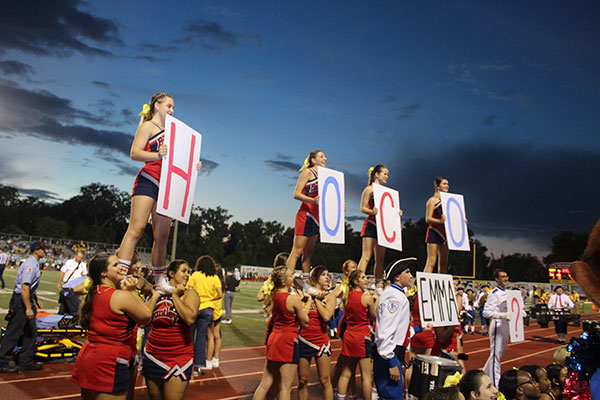 Drum major Dillon Zinno works with the cheerleaders following the halftime show at the football game against Hagerty High School on Friday, Aug. 28 to ask senior Emma Zigenbein to homecoming. The cheerleaders performed a stunt and held signs that said “HOCO” and Zinno held a sign that said “Emma?” Zigenbein said yes. 
