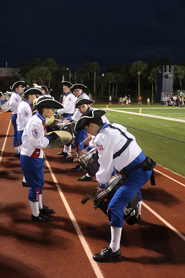 The snare drummers play across from the symbols during the drum circle surrounding the cheerleaders during the third quarter. The football game against Hagerty High School took place on Friday, Aug. 24 on the Tom Storey Field, with the Patriots winning with a score of 35-17. 
