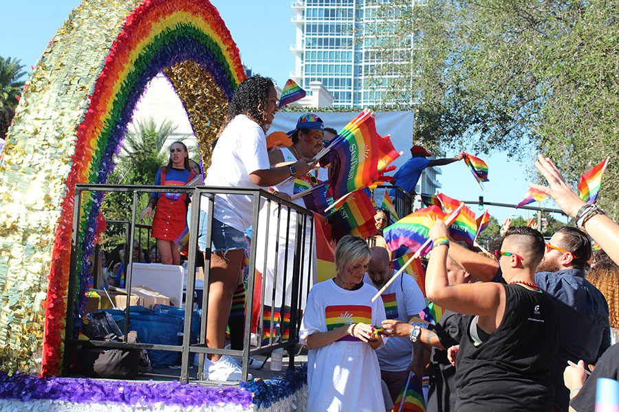 Suntrust employees hand out pride flags and interact with the crowd as they make their way down Magnolia Ave. with the parade. The LGBT+ community and allies celebrated Orlando Pride on Saturday, Oct. 13 at Lake Eola from 10 A.M. to 10 P.M.

