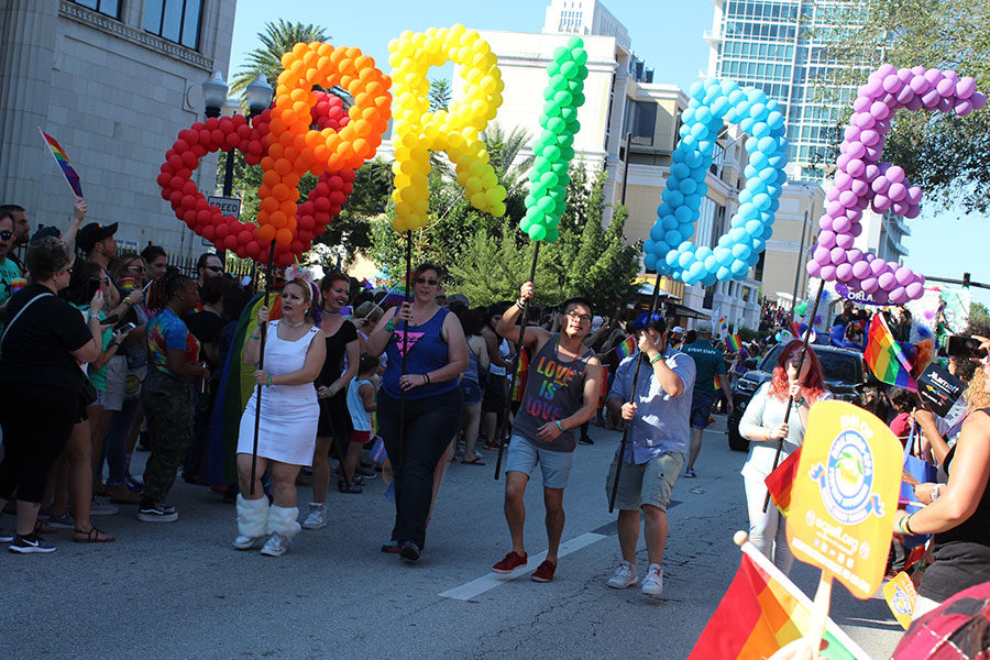 A group walks through Downtown Orlando carrying the Pride balloon letters as the crowd cheers them on while they lead the way for rest of the organizations marching. The LGBT+ community and allies celebrated Orlando Pride on Saturday, Oct. 13,  at Lake Eola from 10 A.M. to 10 P.M.