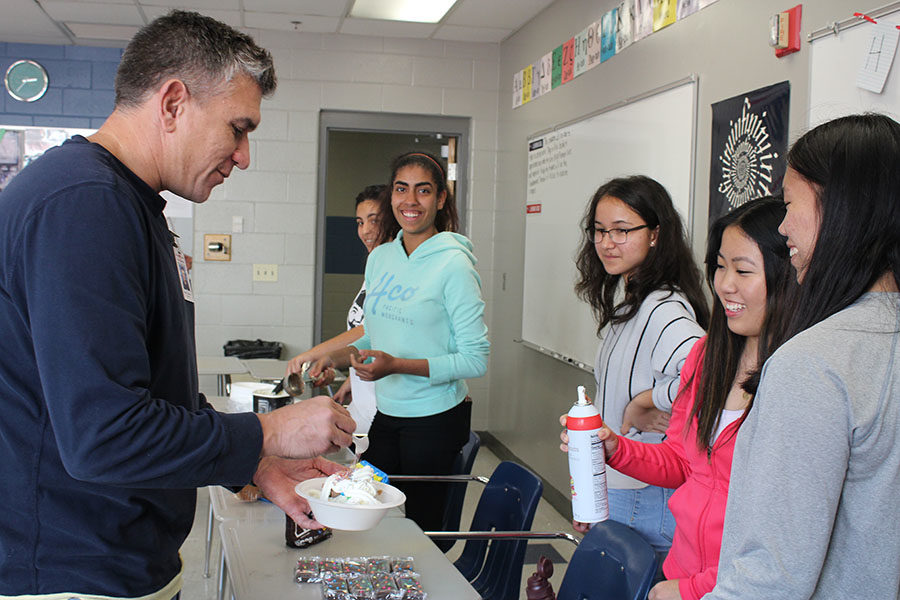 Mu Alpha Theta officers serve ice cream to math teacher Christopher Stanley in Kristine Visavachaipans room on Nov 14. The officers scooped ice cream for the math teachers at their department meeting in honor of American Education Week.