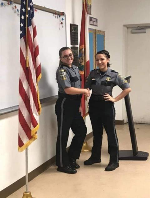 Freshman Rose Gardner and her chief pose for a celebratory photo after Gardner was promoted to the rank of Corporal.