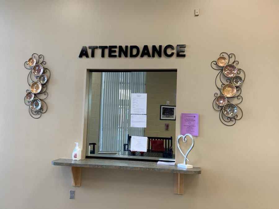The+attendance+desk+in+Building+One+is+where+students+turn+in+absence+excuse+notes+to+Attendance+Secretary+Karen+Wheatley.+Excused+absences+are+included+in+the+absence+total+until+the+student+reaches+15%2C+after+which+absences+must+be+excused+for+a+student+to+avoid+losing+credit.