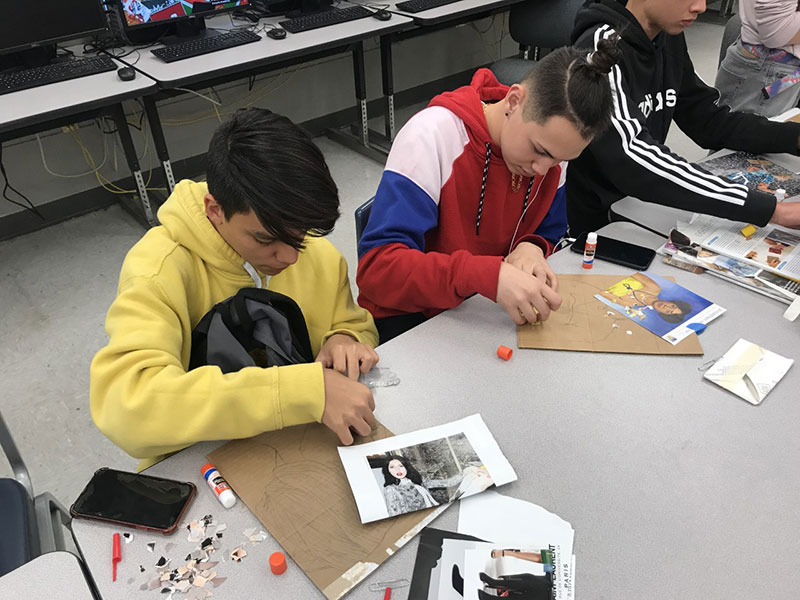 On Feb. 27, students Andres Garcia (left) and Luis Rivera (right), work on gluing their magazine pieces down after sketching out their photo.  “What I like about this project is how we build the picture bottom to top, piece by piece,” Garcia said.
