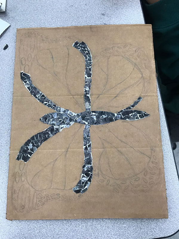 On Feb. 28 student Samantha Peraza is working on her collage for art. The sketch of her butterfly is shown. The pattern that she glues down is shown. “ I like all the different shades and colors that are on it,” Peraza said.