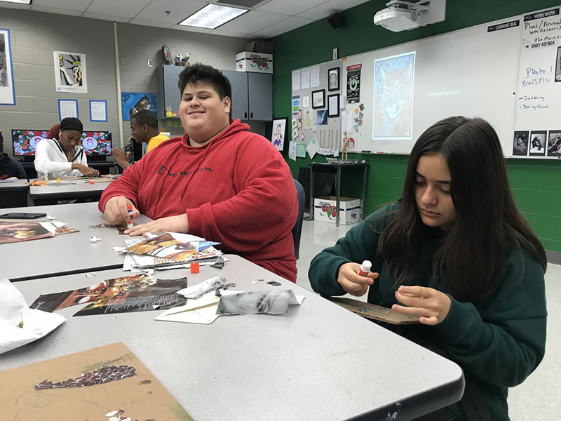 On Feb. 28 Samantha Peraza is shown gluing down her magazine pieces onto her board. All of the materials are present.